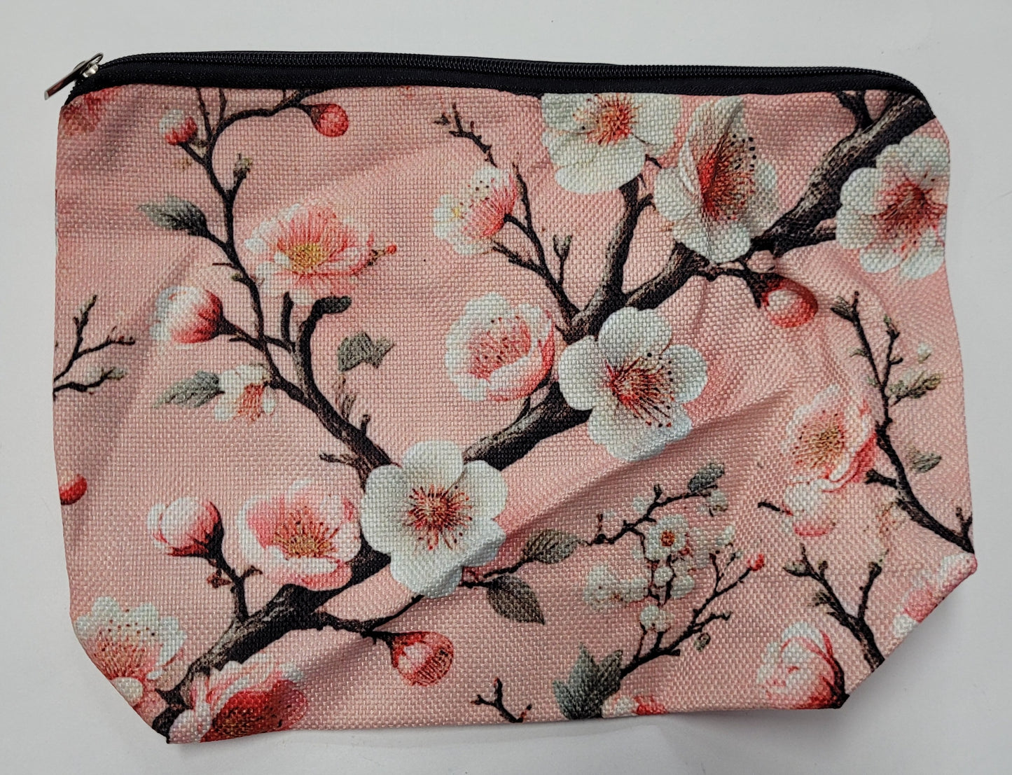 Pouch with cherry blossom design on a pink background