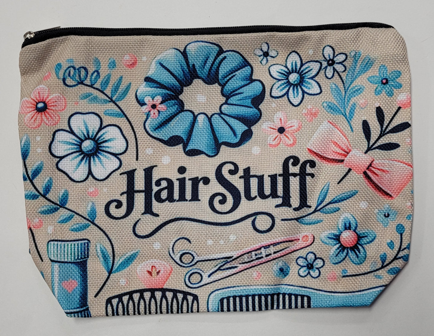 Cosmetic bag with floral designs and 'Hair Stuff' text on a beige background